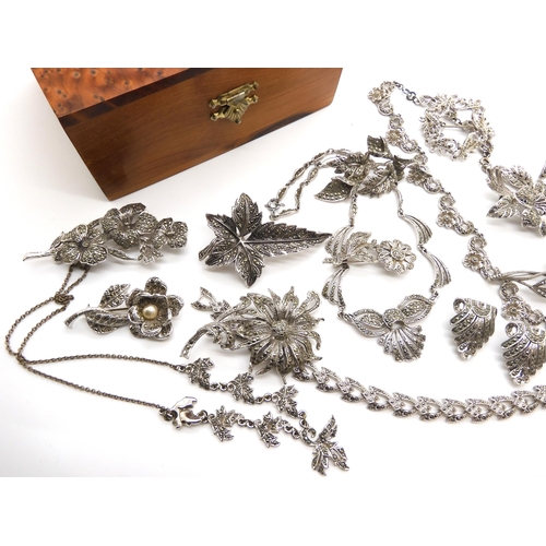 653 - A German silver marcasite flower brooch, together with a collection of further marcazite brooches in... 