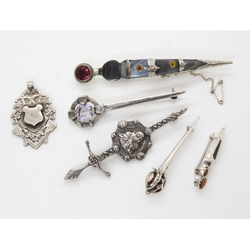 663 - Five silver Scottish themed brooches and a silver medallion