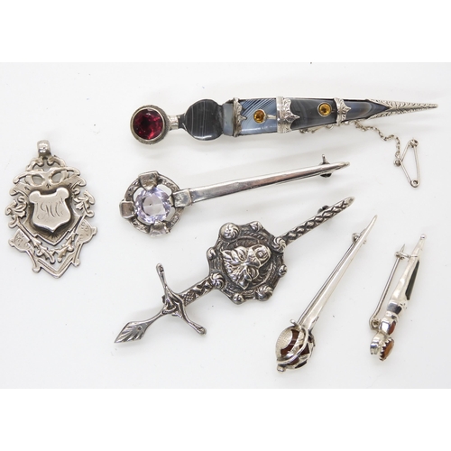 663 - Five silver Scottish themed brooches and a silver medallion