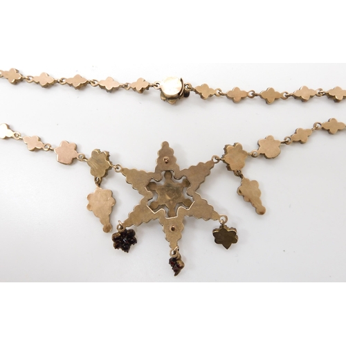 666 - A gilded white metal red gem set star necklace