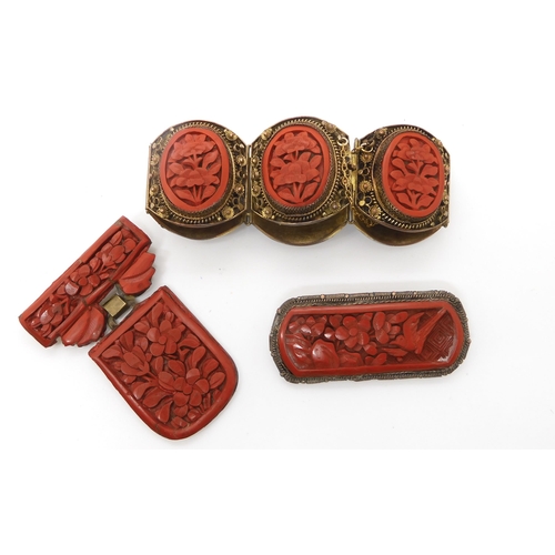 668 - A collection of Cinnabar items to include a bracelet, and two brooches