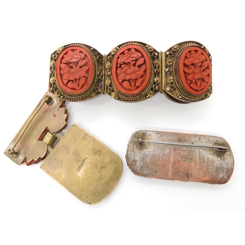 668 - A collection of Cinnabar items to include a bracelet, and two brooches