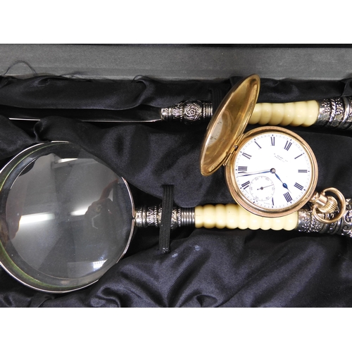 675 - A gold plated Swiss Visible pocket watch, and a boxed set of magnifying glass and paper knife