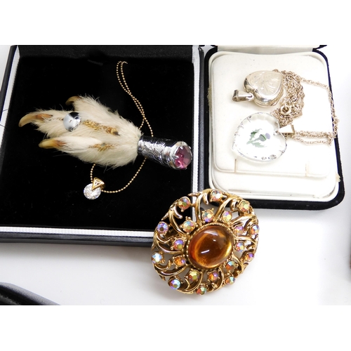 683 - A collection of vintage costume jewellery to include, a string of coral beads and earrings, a grouse... 