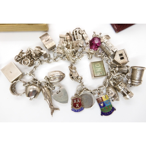 684 - An extensive silver charm bracelet, and a collection of silver and costume jewellery