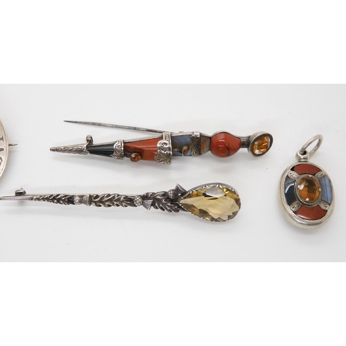 698 - A collection of Scottish themed brooches, to include agate inlaid items, a citrine topped kilt pin e... 