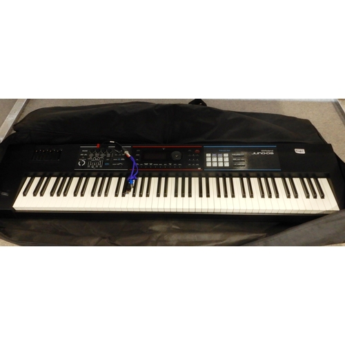 508C - A Roland Juno-DS electric piano with a soft carry case