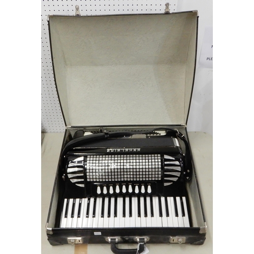 520 - An Excelsior Musette 41 key 120 bass piano accordion model 320 with original case