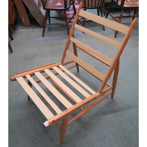 107 - A mid 20th century beech framed Ercol easy chair with green upholstered cushions