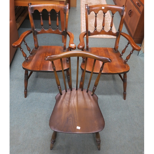 119 - A pair of contemporary stained pine spindle back armchairs and a rail back chair (3)