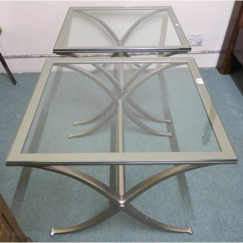 128 - A pair of contemporary steel and glass topped lamp tables, 57cm high x 71cm wide x 61cm deep (2)