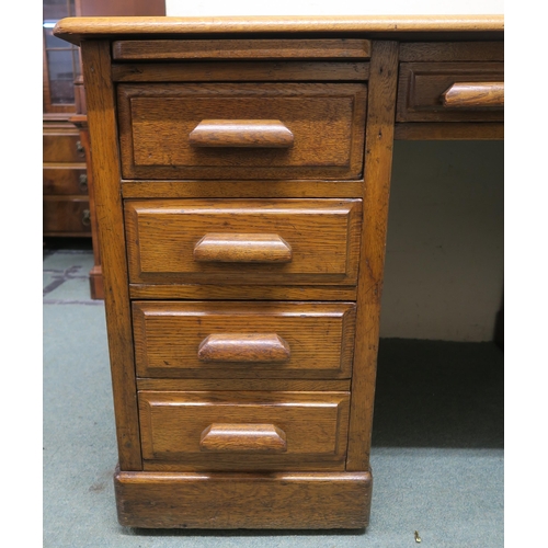 130 - An early 20th century oak pedestal desk, 77cm high x 136cm wide x 81cm deep