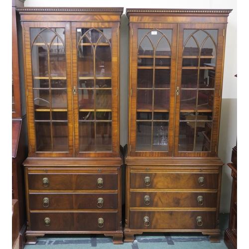 134 - A matched pair of 20th century mahogany glazed bookcases on three drawer chest bases, 176cm high x 7... 