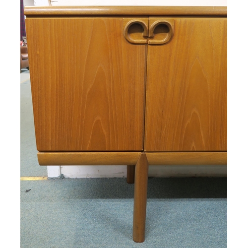 144 - A mid 20th century teak McIntosh of Kirkcaldy sideboard with three central drawers flanked by cabine... 