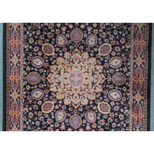 15 - A black ground eastern style rug with central medallion and matching spandrels, 157cm long x 84cm wi... 