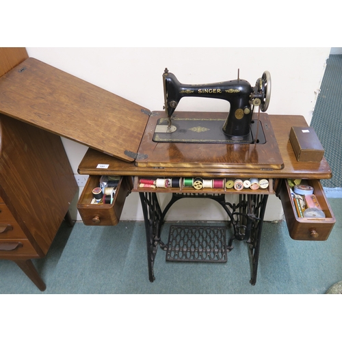 151 - An early 20th century Singer treadle sewing machine with cast iron base