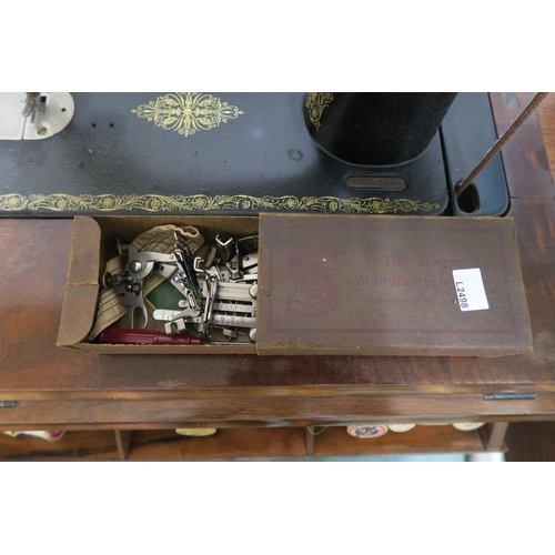 151 - An early 20th century Singer treadle sewing machine with cast iron base