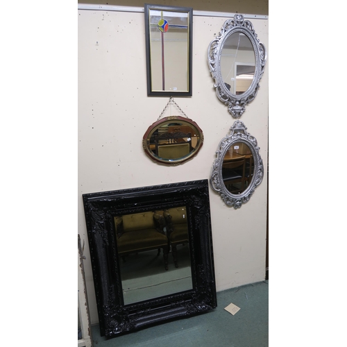 153 - A contemporary black Rococo style wall mirror, two silver framed wall mirrors (one def) and two othe... 