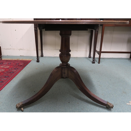 17 - A 20th century reproduction circular tilt top table, 76cm high x 106cm diameter