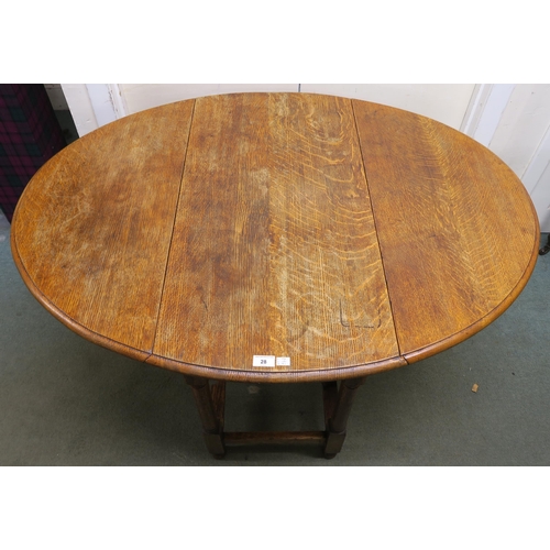 28 - An early 20th century oak drop leaf table, 74cm high x 121cm wide x 91cm deep...