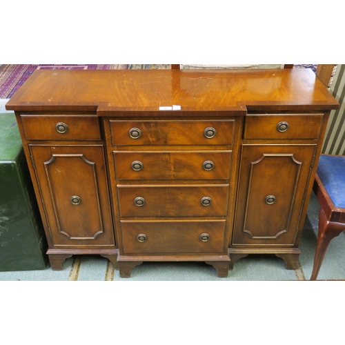 33 - A 20th century mahogany breakfront side unit with four central drawers flanked by a single drawer ab...