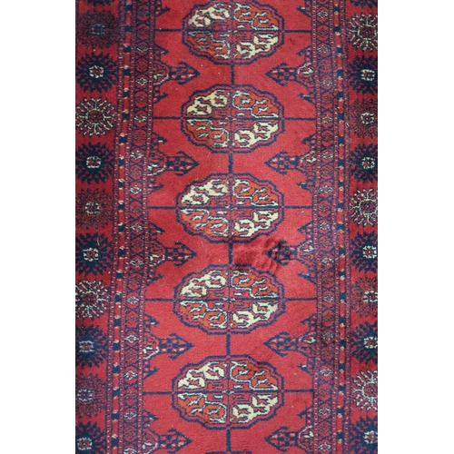 4 - A red ground Bokhara style runner, 273cm long x 69cm wide