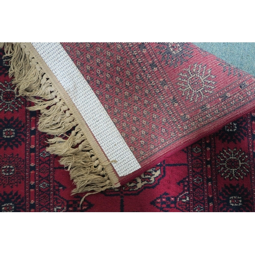 4 - A red ground Bokhara style runner, 273cm long x 69cm wide