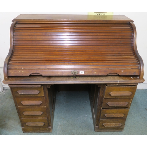 49 - A 20th century oak roll top pedestal desk, 116cm high x 124cm wide x 82cm deep