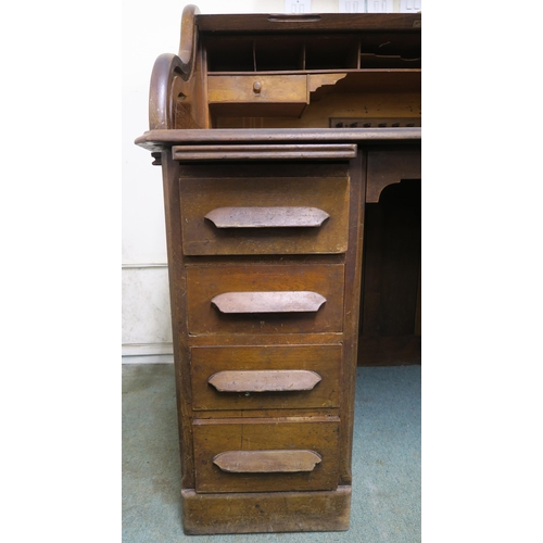 49 - A 20th century oak roll top pedestal desk, 116cm high x 124cm wide x 82cm deep