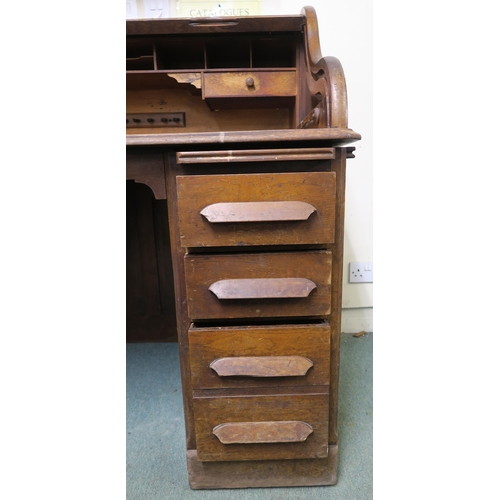 49 - A 20th century oak roll top pedestal desk, 116cm high x 124cm wide x 82cm deep