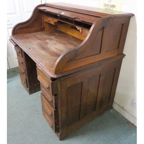 49 - A 20th century oak roll top pedestal desk, 116cm high x 124cm wide x 82cm deep