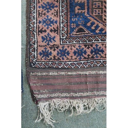 59 - A blue ground Baluch rug with terracotta borders, 164cm long x 89cm wide 