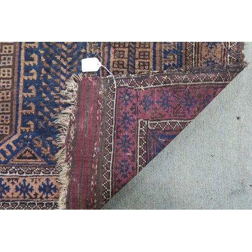 59 - A blue ground Baluch rug with terracotta borders, 164cm long x 89cm wide 