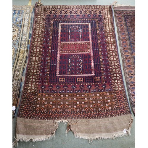 60 - A red ground Turkoman rug with multicoloured borders, 185cm long x 116cm wide