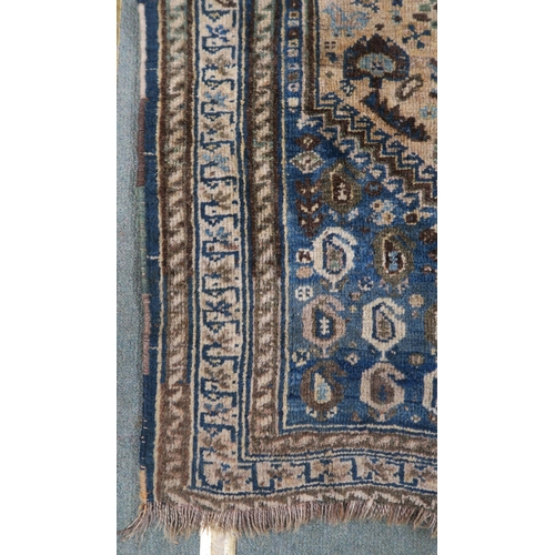 61 - A cream ground eastern rug with blue central medallion and matching spandrels, 156cm long x 110cm wi... 