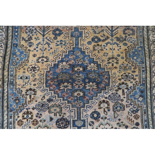 61 - A cream ground eastern rug with blue central medallion and matching spandrels, 156cm long x 110cm wi... 