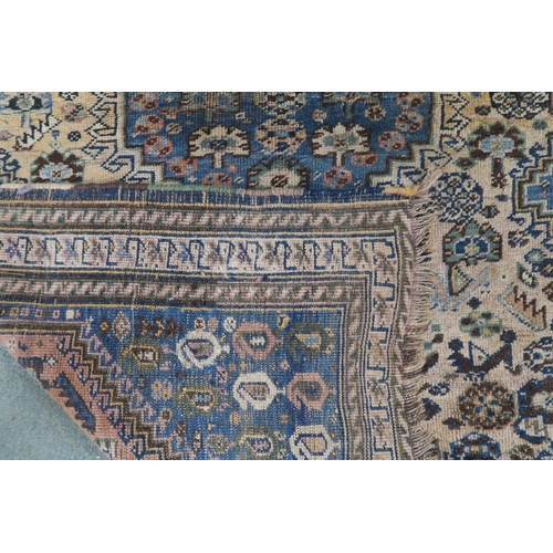 61 - A cream ground eastern rug with blue central medallion and matching spandrels, 156cm long x 110cm wi... 