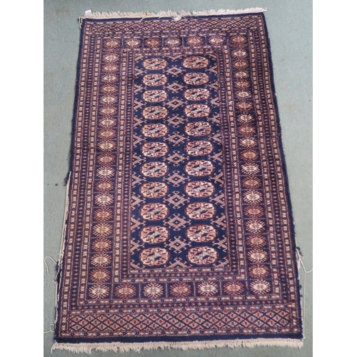 62 - A blue ground Bokhara rug with all over lozenge design, 157cm long x 100cm wide