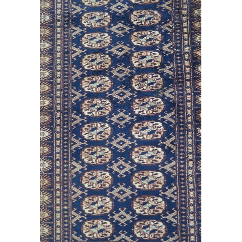 62 - A blue ground Bokhara rug with all over lozenge design, 157cm long x 100cm wide