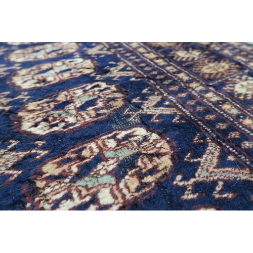 62 - A blue ground Bokhara rug with all over lozenge design, 157cm long x 100cm wide