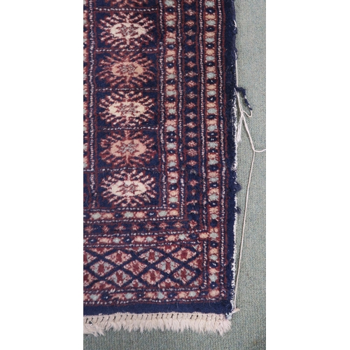 62 - A blue ground Bokhara rug with all over lozenge design, 157cm long x 100cm wide