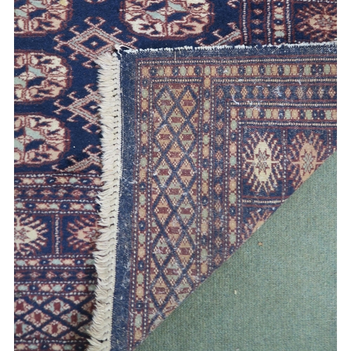 62 - A blue ground Bokhara rug with all over lozenge design, 157cm long x 100cm wide