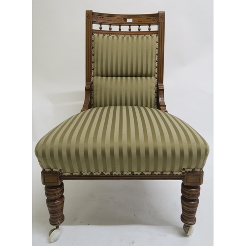 65 - A lot of two late Victorian mahogany parlour chairs one with arms, both upholstered in striped fabri... 