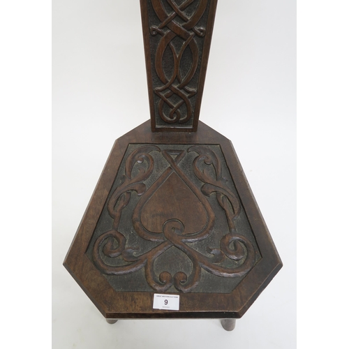 9 - A 20th century oak spinning chair with extensive Celtic carvings