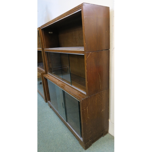 91 - A 20th century oak three tier stacking bookcase with glass sliding doors, 107cm high x 89cm wide x 2... 