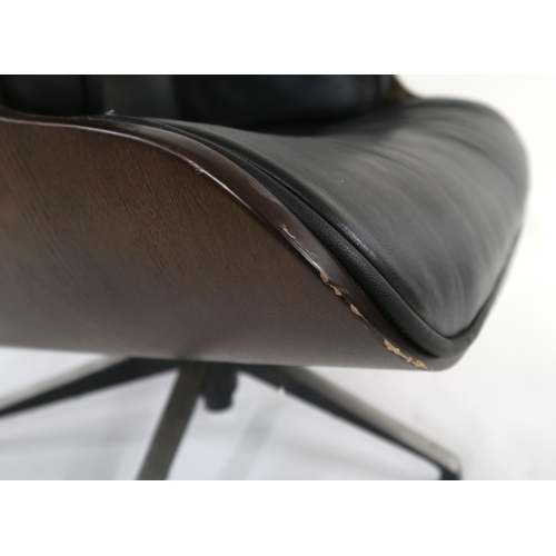 104 - A 20TH CENTURY REVOLVING LOUNGE CHAIR AND FOOTSTOOL IN THE STYLE OF CHARLES AND RAY EAMES FOR HERMAN... 