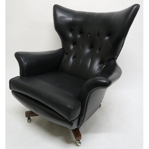 106 - A MID 20TH CENTURY G PLAN 6250 SWIVEL ARMCHAIRupholstered in black Rexine on teak base, 100cm high x... 