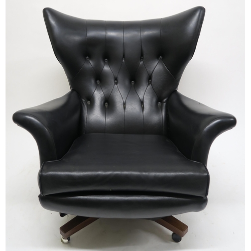 106 - A MID 20TH CENTURY G PLAN 6250 SWIVEL ARMCHAIRupholstered in black Rexine on teak base, 100cm high x... 