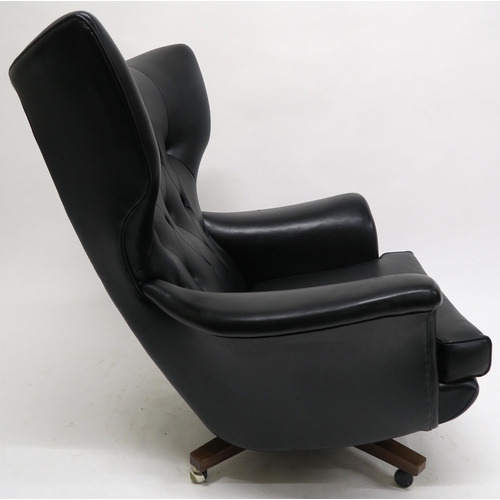 106 - A MID 20TH CENTURY G PLAN 6250 SWIVEL ARMCHAIRupholstered in black Rexine on teak base, 100cm high x... 