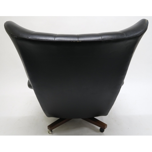 106 - A MID 20TH CENTURY G PLAN 6250 SWIVEL ARMCHAIRupholstered in black Rexine on teak base, 100cm high x... 